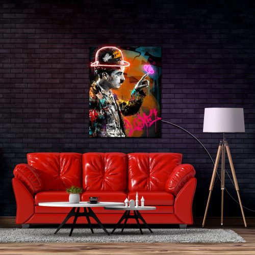 Charlie Chaplin UV light vintage neon artwork displayed on a wall above a red couch with a modern home decor setting.