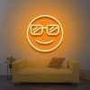 Cool LED Neon Sign featuring a smiling face with sunglasses, glowing yellow above a yellow couch, adding vibrant and fun decor to the room.