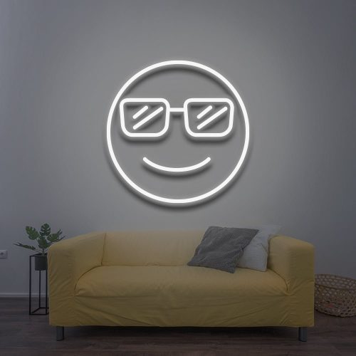 Cool LED Neon Sign featuring a white smiling face with sunglasses, glowing brightly against a light wall, perfect for stylish room decor above a couch.  