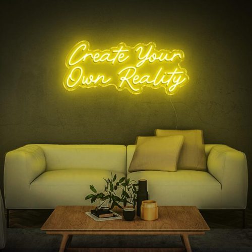 Create Your Own Reality yellow neon sign, perfect for contemporary living room decor and inspirational wall accents.