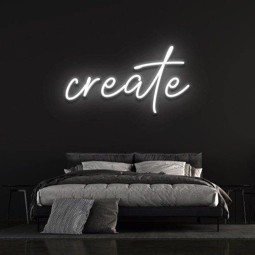 White neon 'Create' sign illuminating a stylish bedroom space, ideal for modern wall art and minimalist decor.